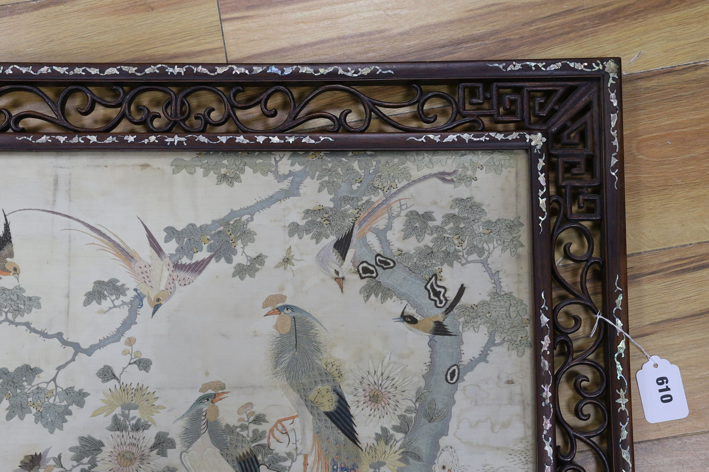 A Chinese mother of pearl inlaid framed and inscribed silk embroidery ‘of the hundred birds’, 78cms wide, 59cms high (including frame)